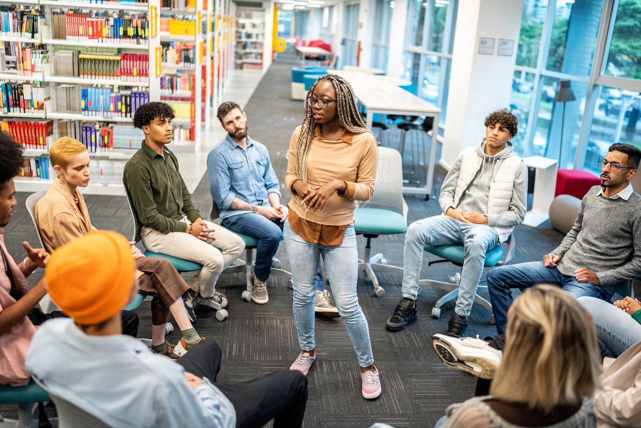 Facilitator speaking to a group in a learning environment