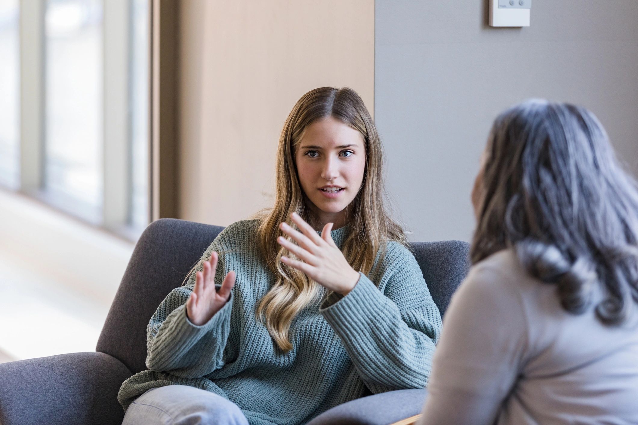 Two people talking in a calm coaching conversation